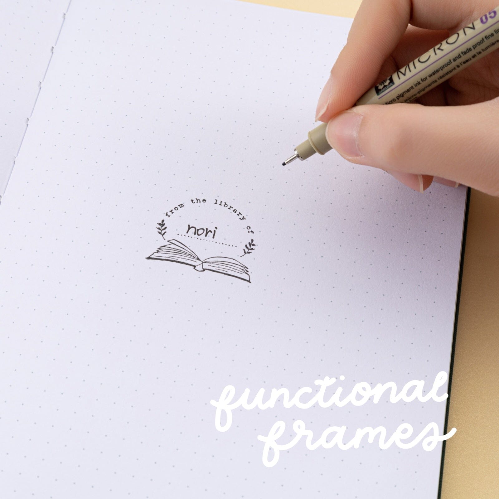 ‘From the library of’ rubber stamp stamped on white dotted paper with text in the middle that reads ‘nori’ and white text on top that reads ‘functional frames’