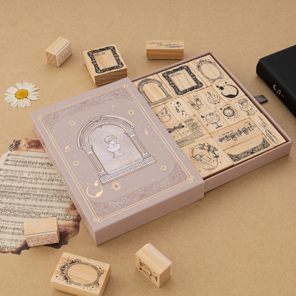 Tsuki Light Academia bullet journal stamp set with opened drawer style box reveaing 16x Light Academia themed stamps