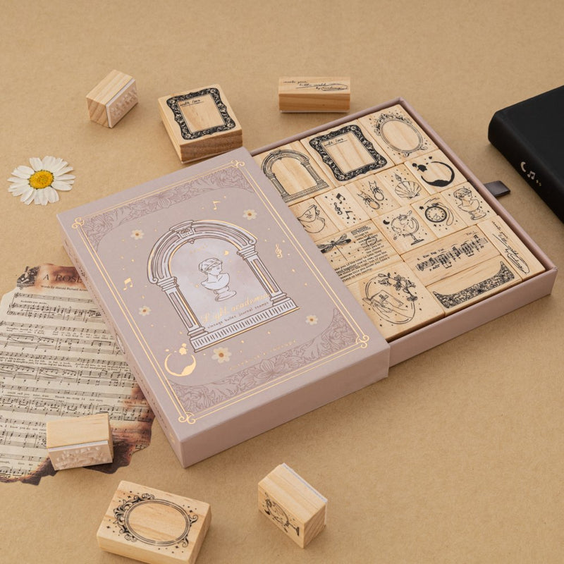 Tsuki Light Academia bullet journal stamp set with opened drawer style box reveaing 16x Light Academia themed stamps
