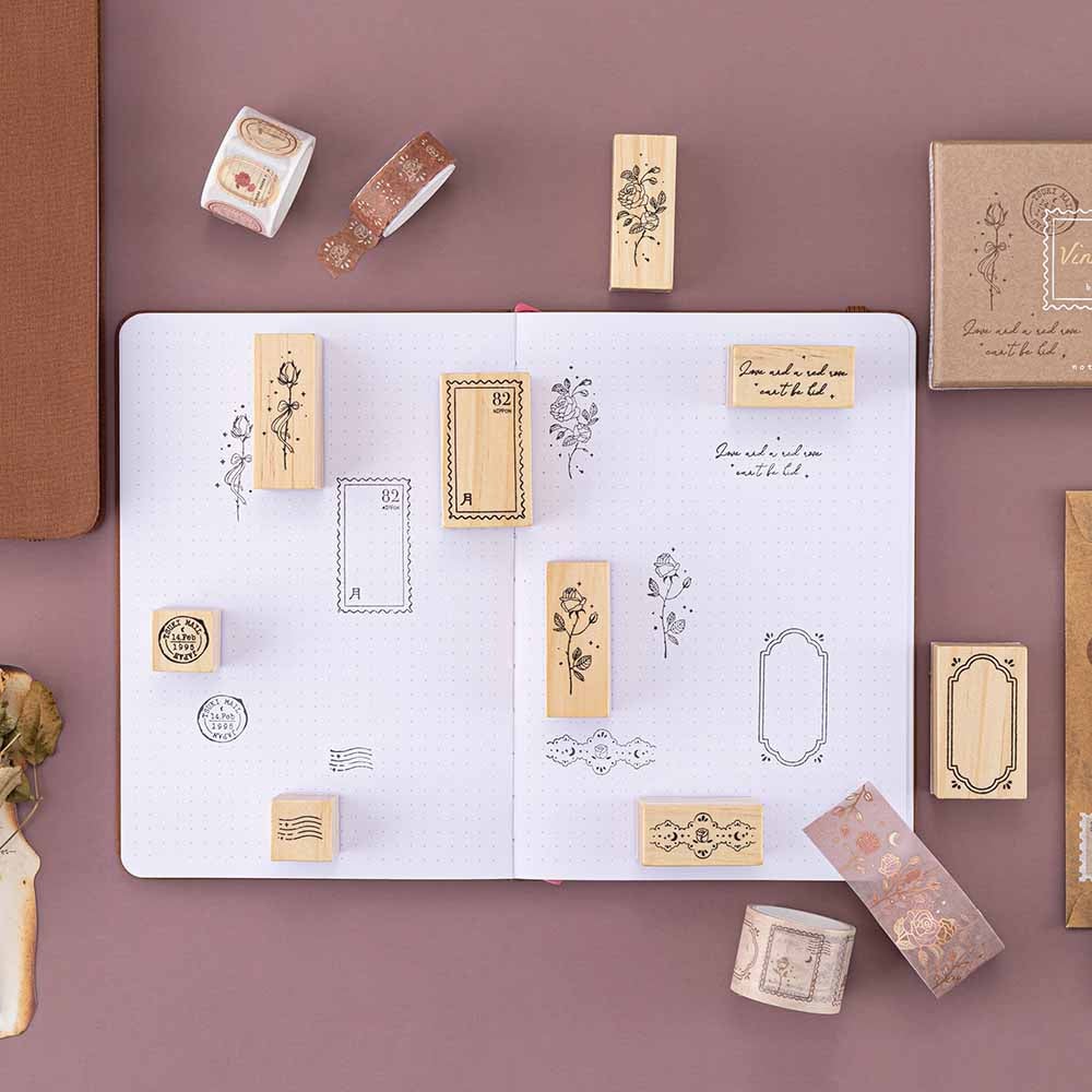 Tsuki ‘Vintage Rose’ Bullet Journal Stamp Set on open Tsuki ‘Vintage Rose’ Limited Edition Bullet Journal with Tsuki ‘Vintage Rose’ Washi Tapes on mauve background