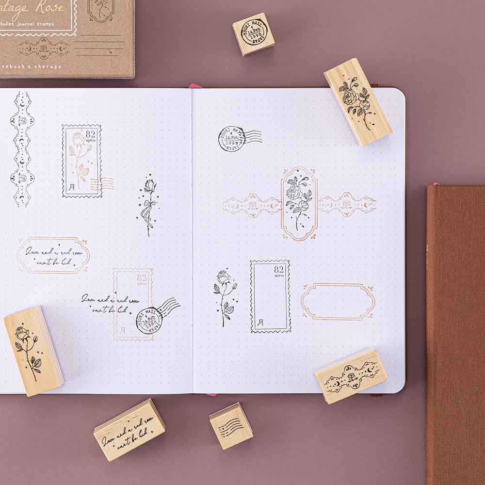 Tsuki ‘Vintage Rose’ Bullet Journal Stamp Set with vintage aesthetic on open Tsuki ‘Vintage Rose’ Limited Edition Bullet Journal on mauve background