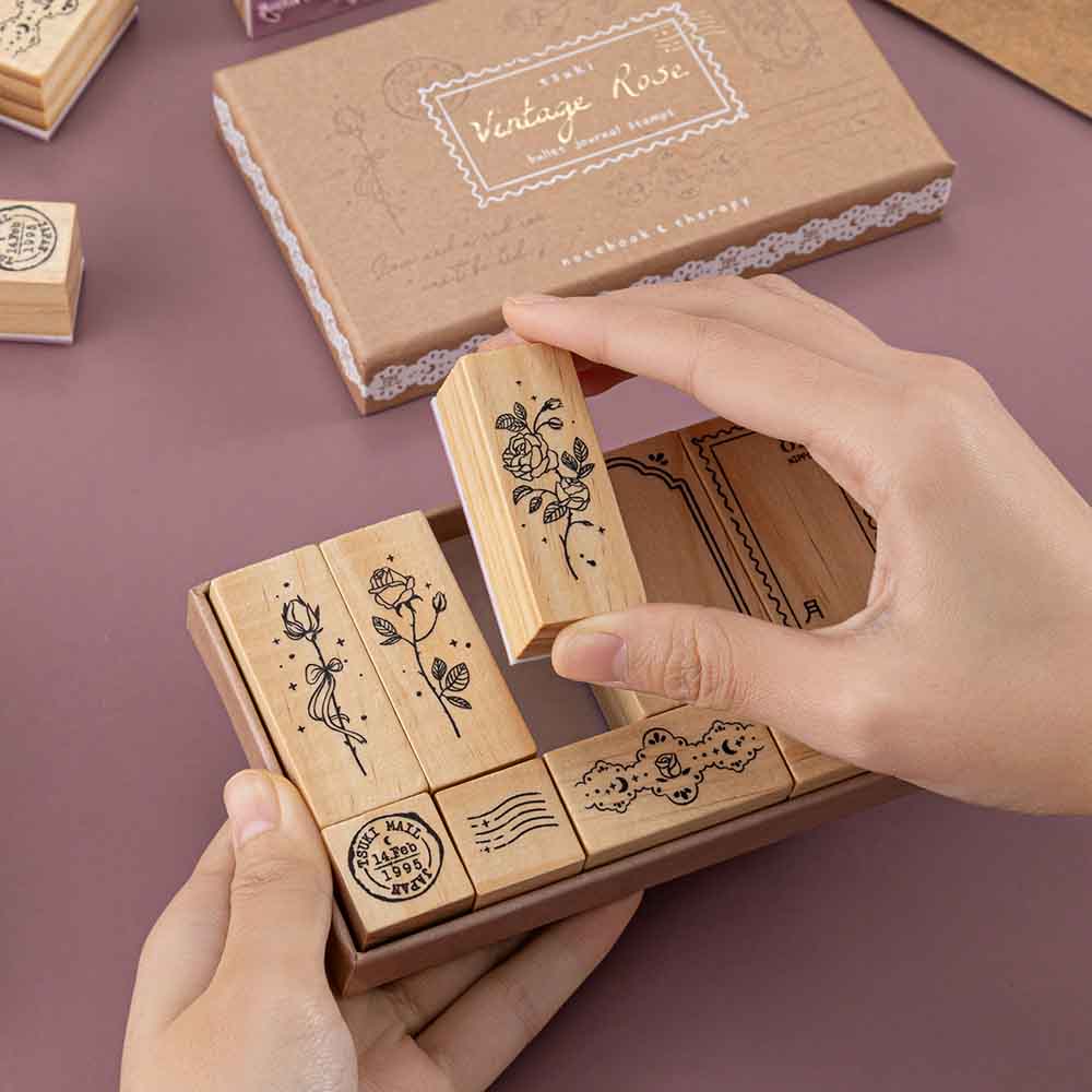 Tsuki ‘Vintage Rose’ Bullet Journal Stamp Set held in hands in mauve background