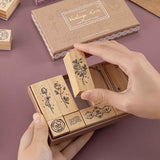 Tsuki ‘Vintage Rose’ Bullet Journal Stamp Set held in hands in mauve background
