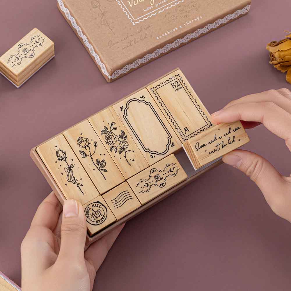 Tsuki ‘Vintage Rose’ Bullet Journal Stamp Set held in hands in mauve background
