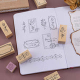 Tsuki ‘Vintage Rose’ Bullet Journal Stamp Set with vintage aesthetic on open Tsuki ‘Vintage Rose’ Limited Edition Bullet Journal with burnt paper and dried roses on mauve background