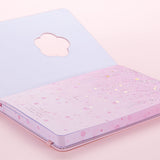 Close up of open front page of Tsuki Four Seasons: Spring Collector’s Edition 2022 Bullet Journal with beautiful sakura design on light pink background