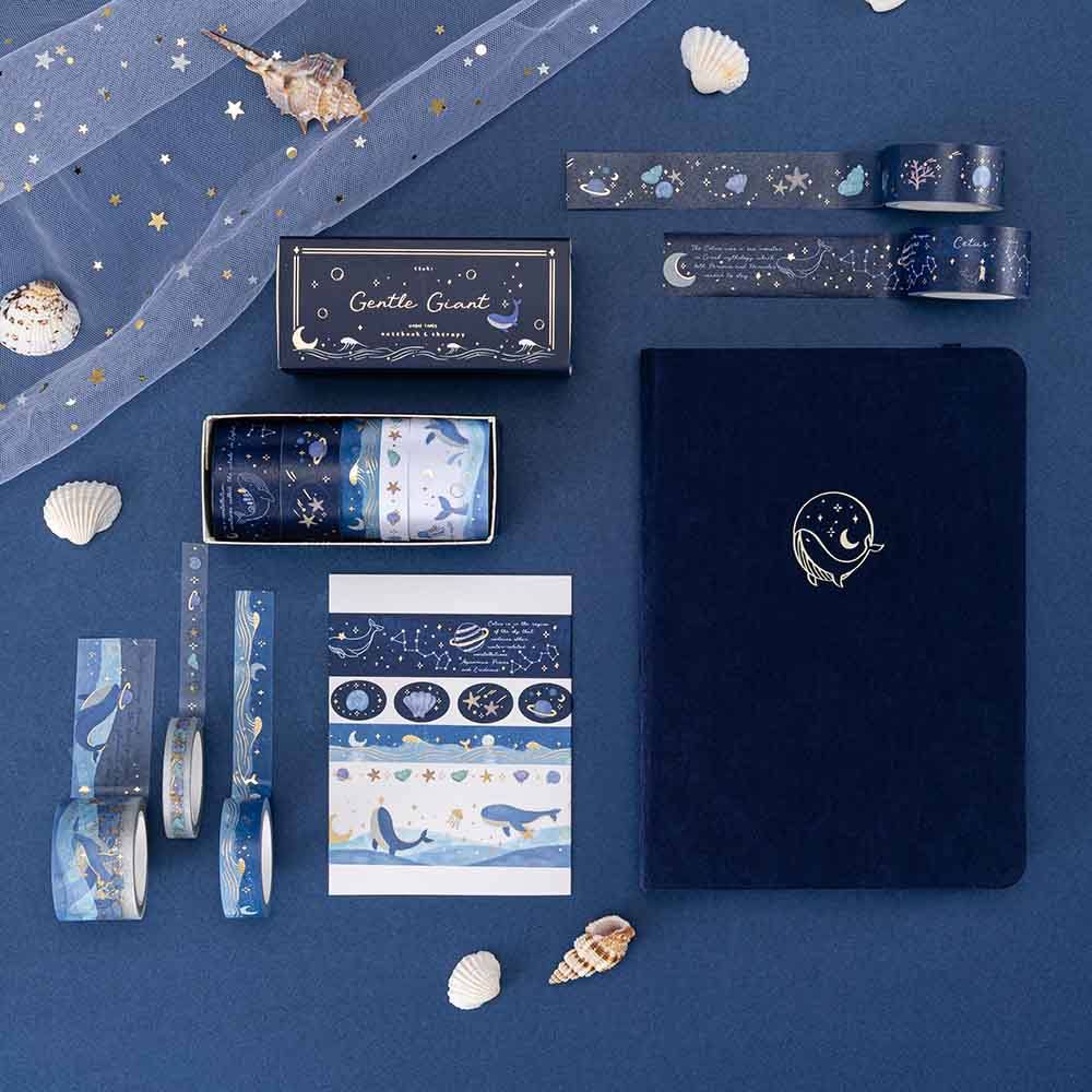 Tsuki Gentle Giant collection featuring deep blue velvet bullet journal and a set of ocean-themed wash tapes against deep blue background with seashells + white net decoration