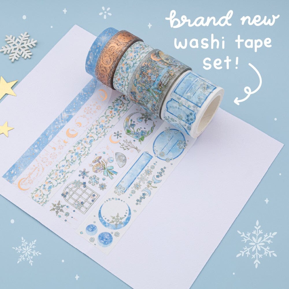 Tsuki Winter Moonflower washi tape set unrolled on white paper with the text “brand new washi tape set!”