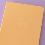Close up of front cover of Tsuki Honey Butter ‘Bunny Blush’ Limited Edition Bullet Journal designed with Blossom Bujo on lilac background