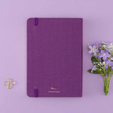 Tsuki ‘Enchanted Garden’ back cover on purple linen bullet journal on purple background