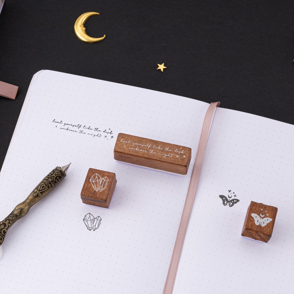 3x wooden stamps on white page dotted bullet journal