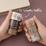 Hands holding 7x washi rolls