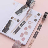 Constellations washi tape set swatched on white page dotted bullet journal laid out on pink background
