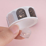 Constellations washi tape sticker roll, one sticker close up shot on finger