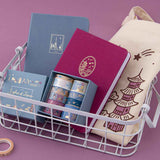 Tsuki Sights of Japan collection in wire basket on pink background