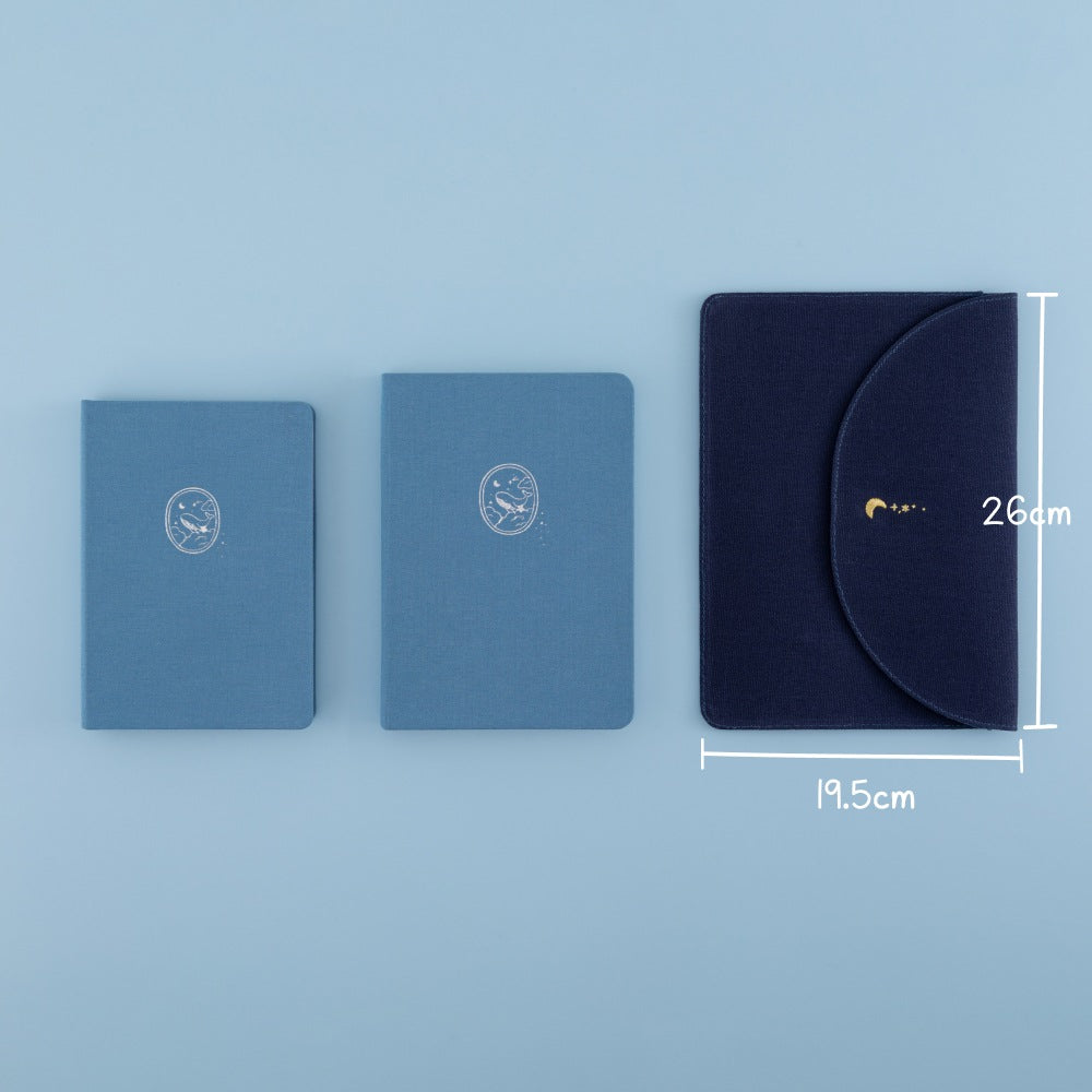 Flatlay of Tsuki Cloud Dreamland notebook pouch with 2 Tsuki Nami notebooks in original size and A5 