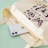 Tsuki ‘Flutter + Dream’ Tote Bag by Notebook Therapy x Pelinkan with mobile phone inside on mint background
