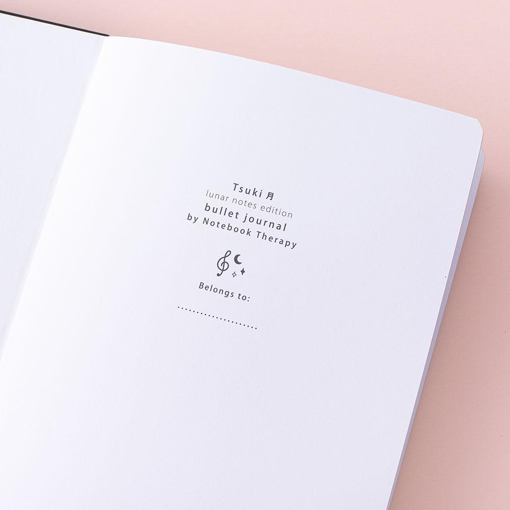 Close up of Tsuki Lunar Note bullet journal opening page image on pink background