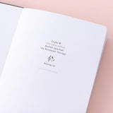 Close up of Tsuki Lunar Note bullet journal opening page image on pink background