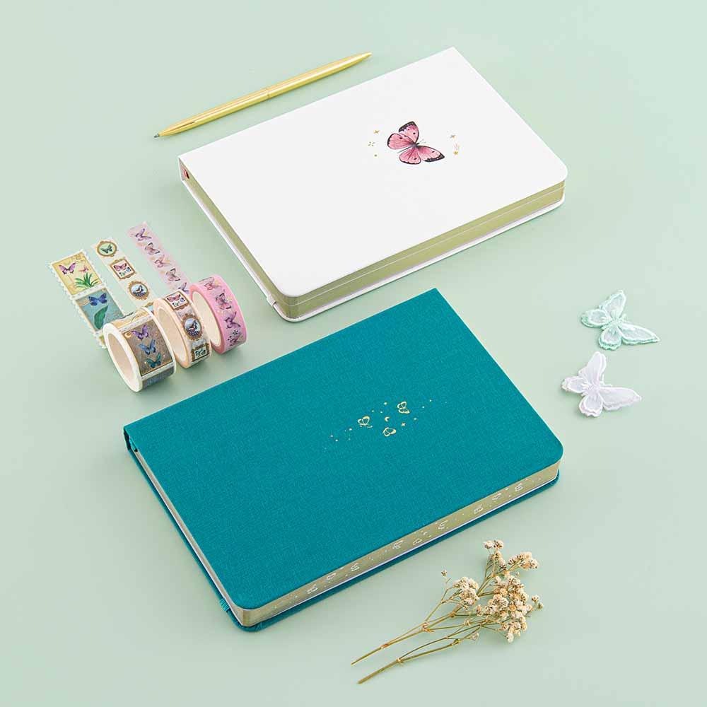 Tsuki Teal Sky ‘Flutter + Dream’ Limited Edition Bullet Journal by Notebook Therapy x Pelinkan and Tsuki Cloud White ‘Flutter + Dream’ Limited Edition Bullet Journal by Notebook Therapy x Pelinkan with Tsuki ‘Flutter + Dream’ Washi Tape Set by Notebook Therapy x Pelinkan with gold pen and butterflies and dried flowers on mint background