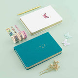 Tsuki Teal Sky ‘Flutter + Dream’ Limited Edition Bullet Journal by Notebook Therapy x Pelinkan and Tsuki Cloud White ‘Flutter + Dream’ Limited Edition Bullet Journal by Notebook Therapy x Pelinkan with Tsuki ‘Flutter + Dream’ Washi Tape Set by Notebook Therapy x Pelinkan with gold pen and butterflies and dried flowers on mint background