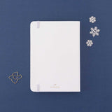 Back cover of Tsuki ‘Winter Journey’ Limited Edition Bullet Journal with free paperclip gift on navy background