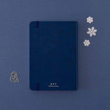 Back cover of Tsuki ‘Winter Wishes’ Limited Edition Bullet Journal with free paperclip gift on navy background