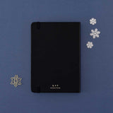Back cover of Tsuki ‘Winter Journey’ Limited Edition Bullet Journal with free paperclip gift on navy background