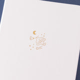 Close up of the front cover of Tsuki ‘Suzume’ Winter Limited Edition Bullet Journal on navy background