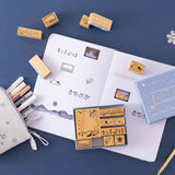 Tsuki ‘Dreams of Snow’ Bullet Journal Stamp Set and Tsuki ‘Dreams of Snow’ Holographic Washi Tapes on open bullet journal spread with Tsuki ‘Dreams of Snow’ Pop-Up Pencil Case in Playful Penguin with snowflake on navy background