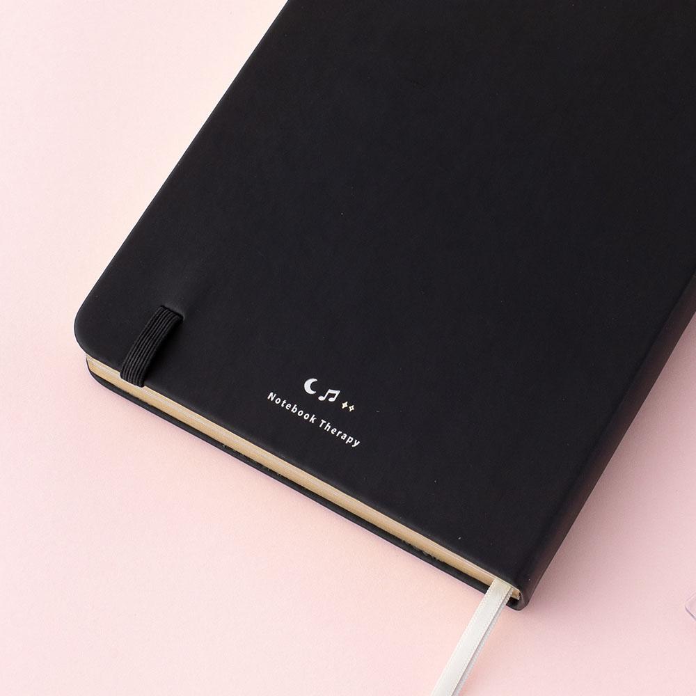 Close up of Tsuki Lunar Notes bullet journal back cover detail image on pink background