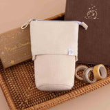 Tsuki ‘Maple Dreams’ Pop-Up Pencil case in stone with Tsuki ‘Nara’ Limited Edition Bullet Journal and Tsuki ‘Maple Dreams’ Bullet Journal Stamp Set and Tsuki ‘Maple Dreams’ Washi Tapes in brown basket on beige background
