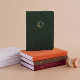 Tsuki ‘Midnight Garden’ Limited Edition Bullet Journal with Tsuki ‘Kitsune’ Limited Edition notebook and Tsuki ‘Nara’ Limited Edition Bullet Journal and Tsuki ‘Kinoko’ Limited edition bujo with eco-friendly gift boxes with Tsuki ‘Maple Dreams’ Washi Tapes on beige background