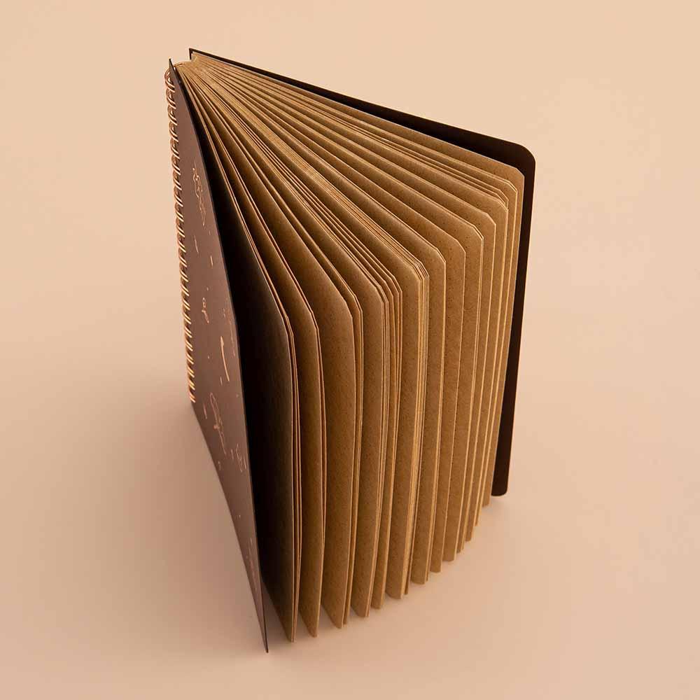 Tsuki ‘Maple Dreams’ Kraft Paper Ringbound Bullet Journal fanned open on beige background