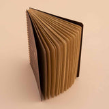 Tsuki ‘Maple Dreams’ Kraft Paper Ringbound Bullet Journal fanned open on beige background
