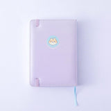 Close up of the back cover of Tsuki Four Seasons: Summer Edition Bullet Journal designed with @milkkoyo on lilac background