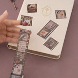 Hands holding brown kraft paper card with washi tape collage
