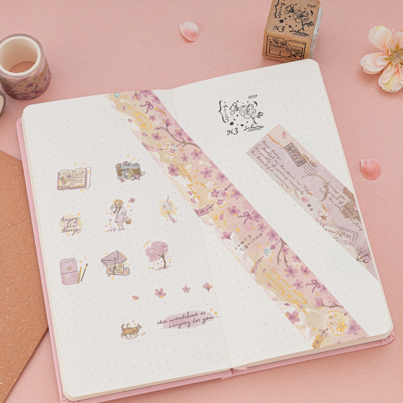 Cherry blossom themed washi tapes and stickers on bullet journal