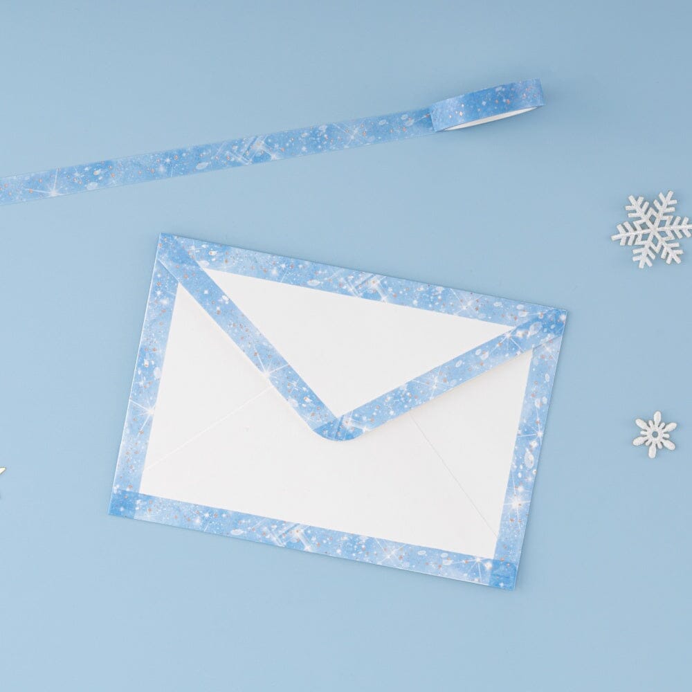 Blue sparkly snow washi tape on edges of white envelope