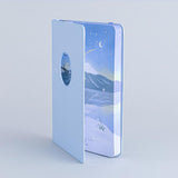 Tsuki Four Seasons Winter Collector’s Edition Bullet Journa at an angle in light blue background