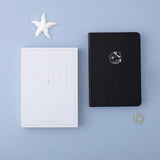 Tsuki deep black Playful Orca limited edition notebook with eco-friendly gift box and starfish and free sunshine gift on blue background