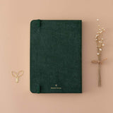 Back cover of Tsuki ‘Midnight Garden’ Limited Edition Bullet Journal with free paperclip gift and dried flowers on beige background