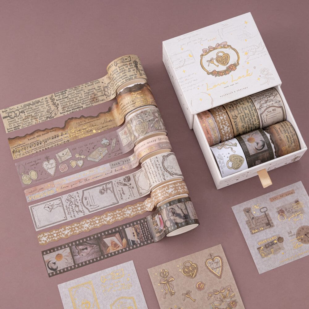 Flatlay of Tsuki Love Lock collection including notebook with key design, stamp set and washi tape set