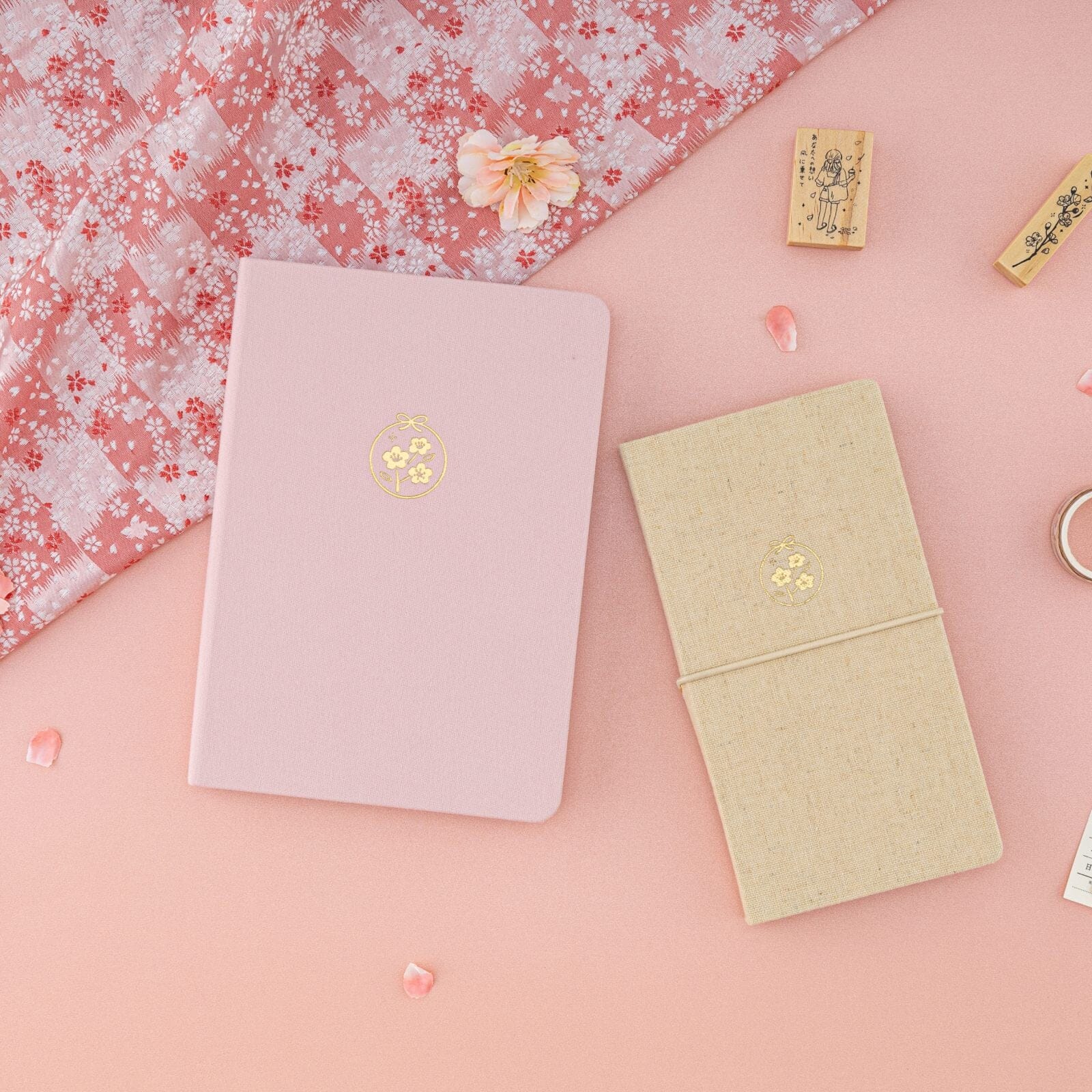 Flatlay including Sakura Breeze bullet journal and kraft paper travel notebook