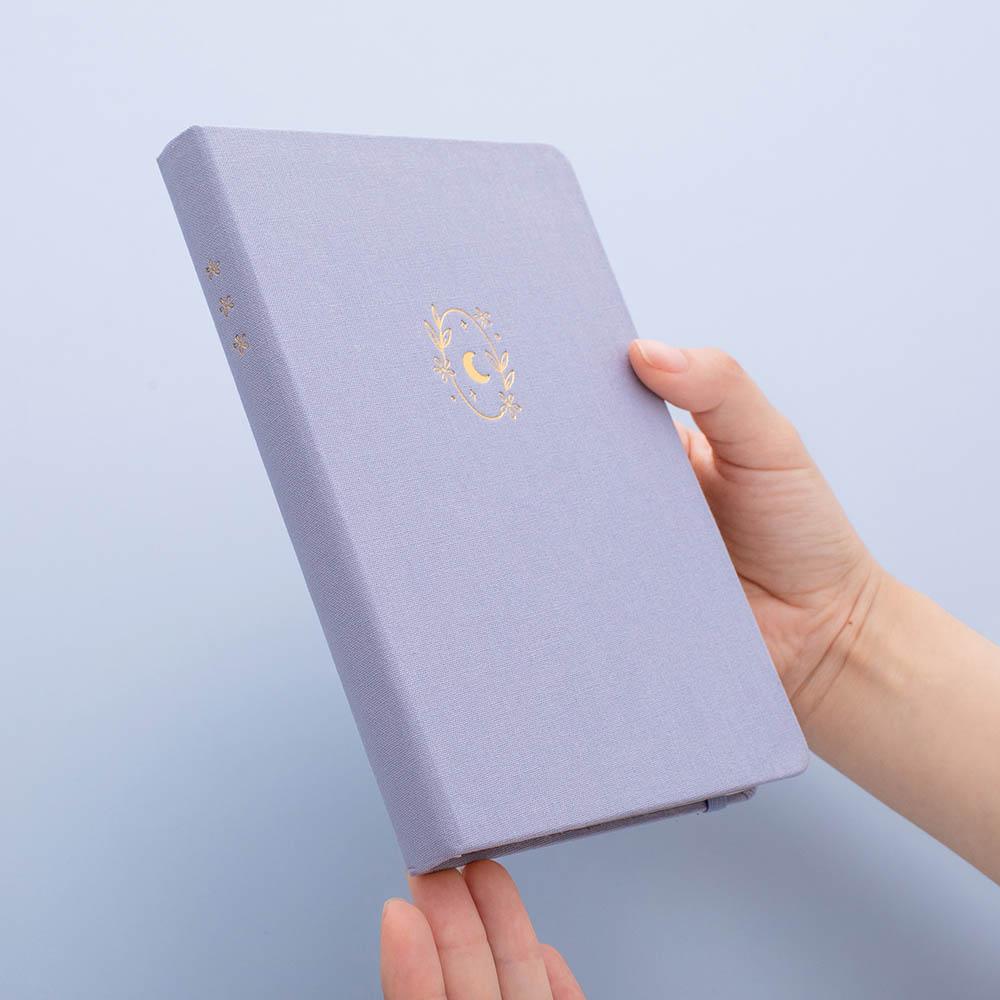 Tsuki ‘Full Bloom’ Limited Edition Bullet Journal held in hands in lilac background