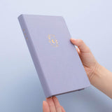 Tsuki ‘Full Bloom’ Limited Edition Bullet Journal held in hands in lilac background