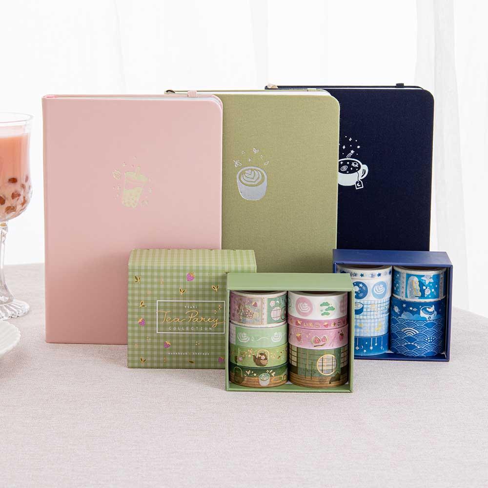 Tsuki ‘Matcha Matcha’ Limited Edition Bullet Journal and Tsuki ‘Matcha Ichigo’ Washi Tape Set and Tsuki ‘Ichigo’ Limited Edition Boba Bullet Journal and Tsuki ‘Cup of Galaxy’ Limited Edition Holographic Bullet Journal and Tsuki ‘Cup of Galaxy’ Washi Tape Set with strawberry bubble tea on linen covered table