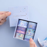 Tsuki Endless Summer Washi Tape Set with eco-friendly gift box packaging held in hands with Tsuki Endless Summer Pop Up Pencil case in petal blue on light blue background