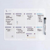 Tsuki Reusable Weekly Planner with dry erase marker on light grey surface