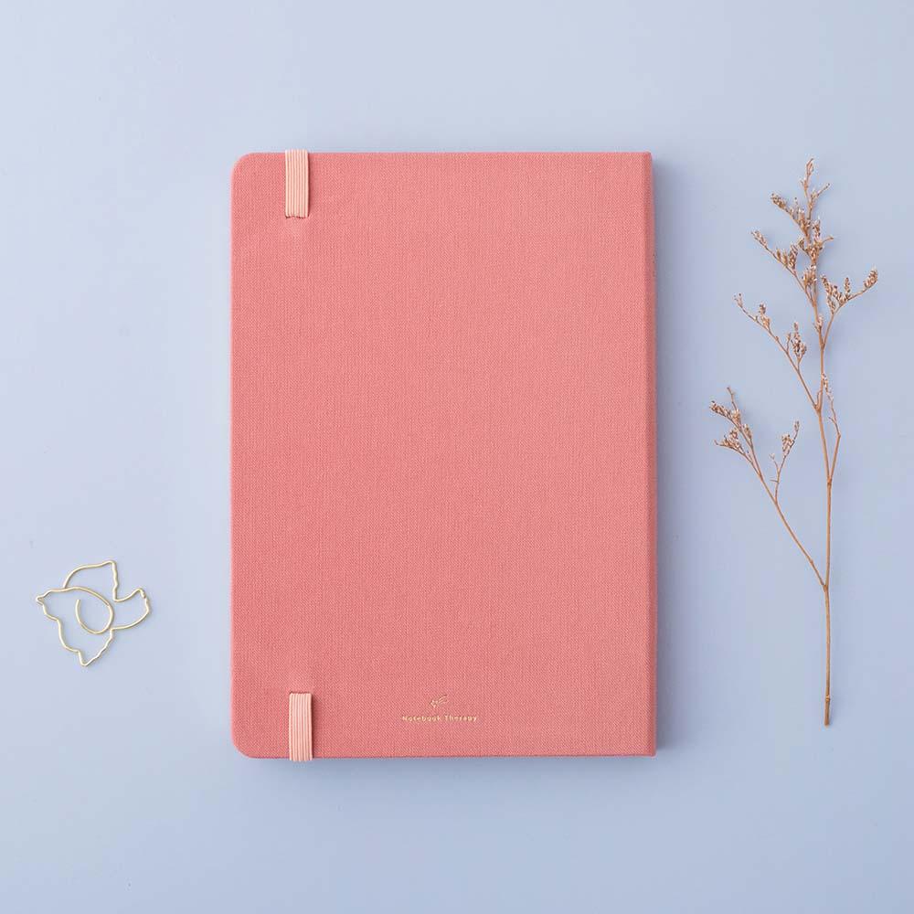 Back cover of Tsuki ‘Suzume’ Limited Edition Bullet Journal with free gift and flowers on lilac background